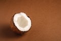 Single coconut fruit on brown plain background, abstract food tropical concept Royalty Free Stock Photo