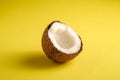 Single coconut fruit on yellow plain background, abstract food tropical concept Royalty Free Stock Photo