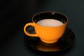 Single coffee cup, yellow and black ceramic, on dark background Royalty Free Stock Photo