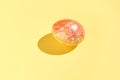 Single colorful easter egg on vibrant yellow background with decorative Royalty Free Stock Photo