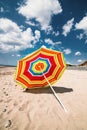 Single colourful umbrella sunny day Aberdovey Wales empty beach Royalty Free Stock Photo