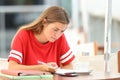 Confused student studying in a coffee shop