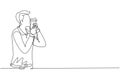 Single continuous line drawing handsome man kissing disposable coffee cup or paper cup. Coffee product studio photo session.