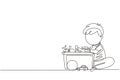 Single continuous line drawing little boy putting his toys into box. Kids doing housework chores at home concept. Smiling child