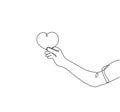 Single continuous line drawing of young happy female hand holding cute heart shaped carton paper. Romantic marriage love concept.