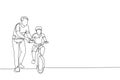 Single continuous line drawing of young kids boy learning ride bicycle with father at outdoor park. Parenthood lesson. Family time Royalty Free Stock Photo