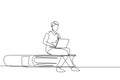 Single continuous line drawing young man studying with laptop and sitting on big book. Back to school, intelligent student, online Royalty Free Stock Photo
