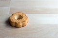 Single cookie on wooden desk. Nature light and shadows