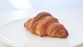 Single croissant in white background