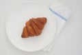 Single croissant in white background