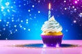 single cupcake adorned with white frosting, glitter and lit birthday candle, soft bokeh background. concepts: birthday Royalty Free Stock Photo