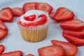 A single cupcake with strawberry slices on white background Royalty Free Stock Photo