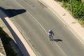 A single cyclist pedaling down a lonely road.