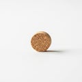 A single cylindrical cork stopper stands vertically against a Royalty Free Stock Photo