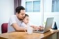 Single dad and son using laptop together happily. Technology and Royalty Free Stock Photo