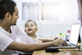 Single dad and son using laptop together happily. Technology and Royalty Free Stock Photo