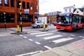 Single Decker Red Bus Approching A Zebra Or Pedestrian Crossing