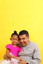 Dad plays with his 4 year old brunette Latina daughter dressed as a ballerina in a tutu practices her ballet class with her dad Royalty Free Stock Photo