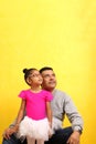 Dad plays with his 4 year old brunette Latina daughter dressed as a ballerina in a tutu practices her ballet class with her dad Royalty Free Stock Photo
