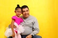 Dad plays with his 4 year old brunette Latina daughter dressed as a ballerina in a tutu practices her ballet class with her dad Royalty Free Stock Photo