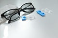 Single dose eye drops, glasses and fabric on table. Space for text Royalty Free Stock Photo