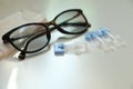 Single dose eye drops, glasses and fabric on white table, closeup Royalty Free Stock Photo