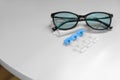 Single dose eye drops, glasses and fabric on white table, space for text Royalty Free Stock Photo