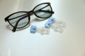 Single dose eye drops and glasses on white table Royalty Free Stock Photo
