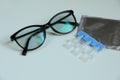 Single dose eye drops and glasses on white table, closeup Royalty Free Stock Photo