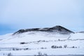 Single dramatic symetrical volcanic,snow covered crater near lake Myvatn, Iceland Royalty Free Stock Photo