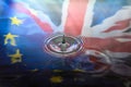 A single drop of water breaking away from a water splash with UK Union Jack and Stars of the European Union EU flags reflected in Royalty Free Stock Photo