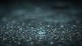 A single drop of water is sitting on a wet surface Royalty Free Stock Photo