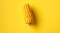 Vibrant yellow corn cob pops against a bright, clean background, perfect for food and harvest themes Royalty Free Stock Photo