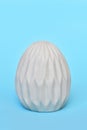 Easter egg with honeycomb pattern on blue background Royalty Free Stock Photo