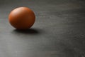 Single egg on the black wood background with copy space Royalty Free Stock Photo