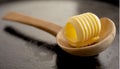 Single elegant butter curl in a wooden spoon Royalty Free Stock Photo