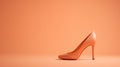 A single elegant colored high-heeled shoe, perfectly positioned against a flat background, symbolizes timeless fashion. Royalty Free Stock Photo