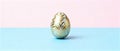 Elegant Golden Easter Egg on Pastel Pink and Blue Background Royalty Free Stock Photo