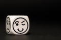 Single emoticon dice with blinking expression sketch Royalty Free Stock Photo