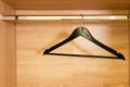 Single empty black clothing rack hanging on coathanger in closet Royalty Free Stock Photo