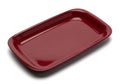 A single empty rectangular dark red ceramic baking dish with rounded corners isolated on a white background showcasing its glossy Royalty Free Stock Photo