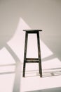 single empty tall wooden stool