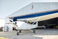 Single-engine airplane stands before aircraft hangar, ready to take off Royalty Free Stock Photo