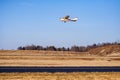 Single Engine Propeller Plane Flying Over Runway in Autumn