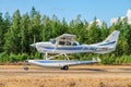 Single-engined piston-powered aircraft with fixed landing gear Cessna T206H Turbo Stationair OH-PAX amphio floats landing on Royalty Free Stock Photo