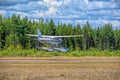 Single-engined piston-powered aircraft with fixed landing gear Cessna T206H Turbo Stationair OH-PAX amphio floats take of from Royalty Free Stock Photo