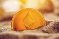 Single ethereum coin in sand