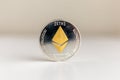 Single ethereum coin on the surface cryptocurrency