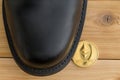 Single Ethereum cryptocurrency coin under a shoe