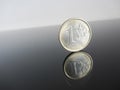 Single Euro coins on grey background Royalty Free Stock Photo